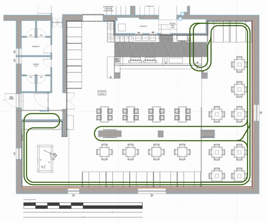 Restaurant floor plan with green electric train route, table layout, bar counter and service area